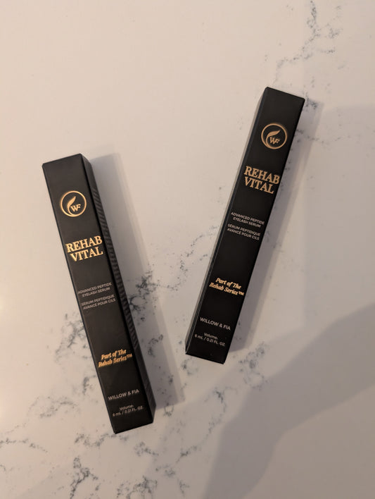 Two black boxes labeled 'Rehab Vital' on a marble surface